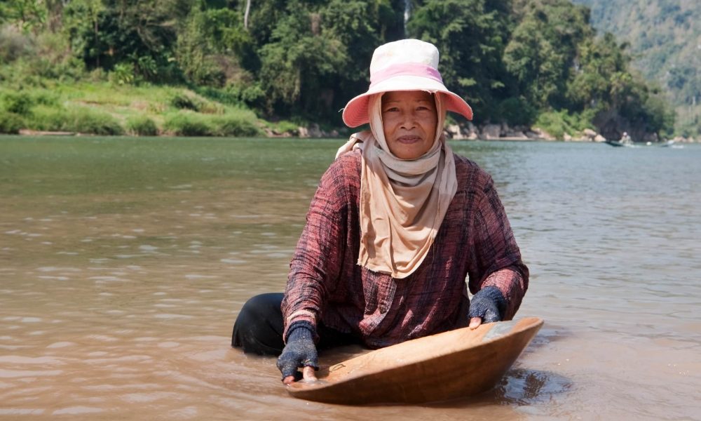 woman washing gold in river, portrait of asian at nam ou in Laos