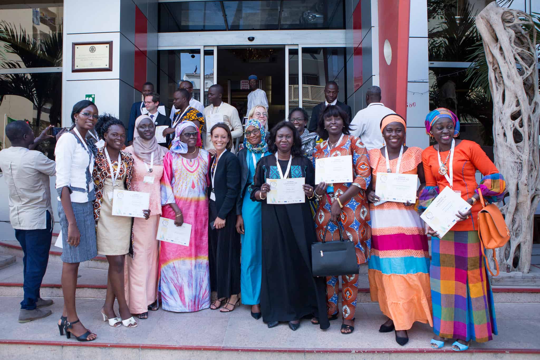 A photograph of ASM workshop participants proudly holding their certificates.