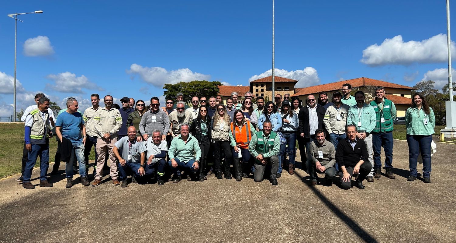 Group of people standing in front of a mine site in Brazil.