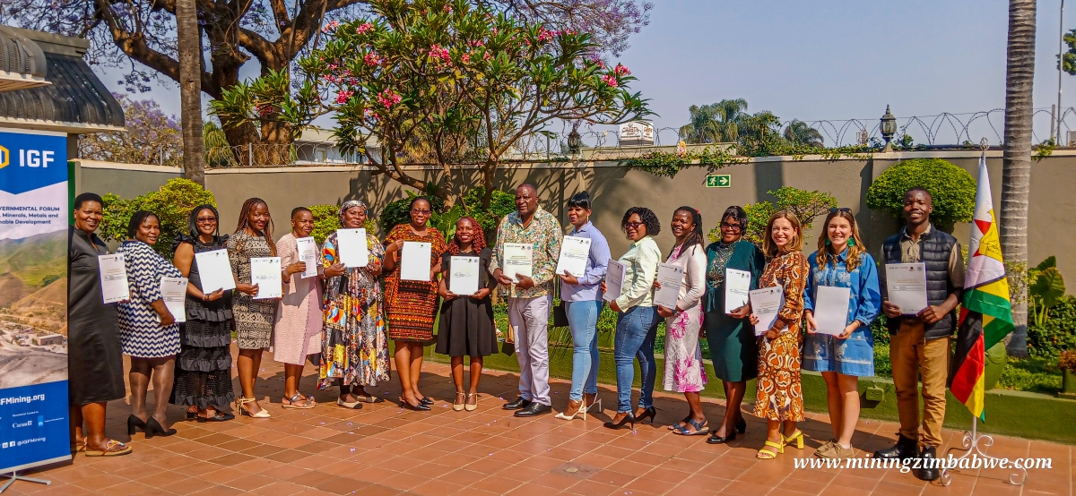 Group of people holding certificates posing for a photo.