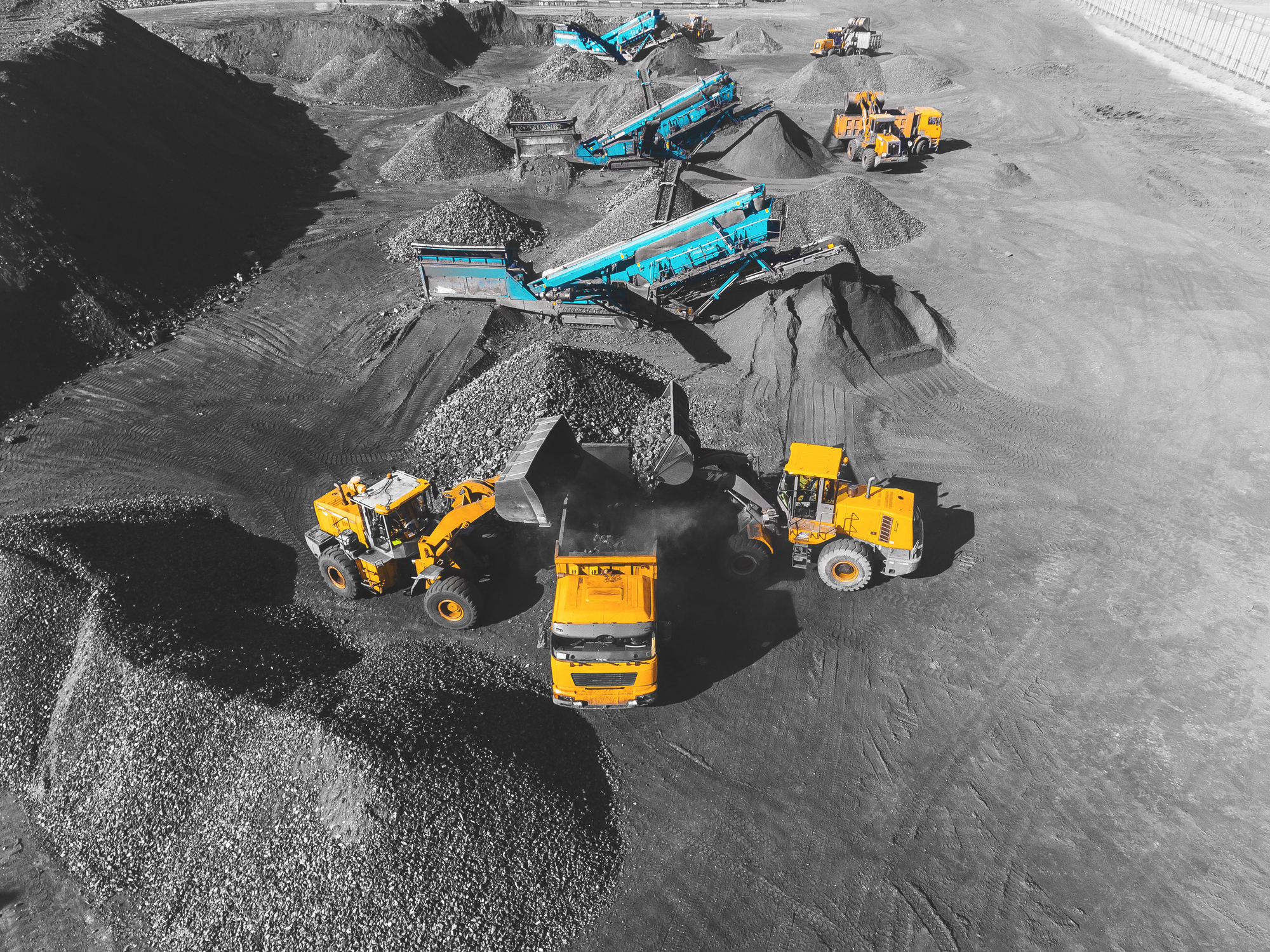 View from above showing the process of sorting coal at an open pit mine.